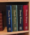 pic of four binders on a bookcase